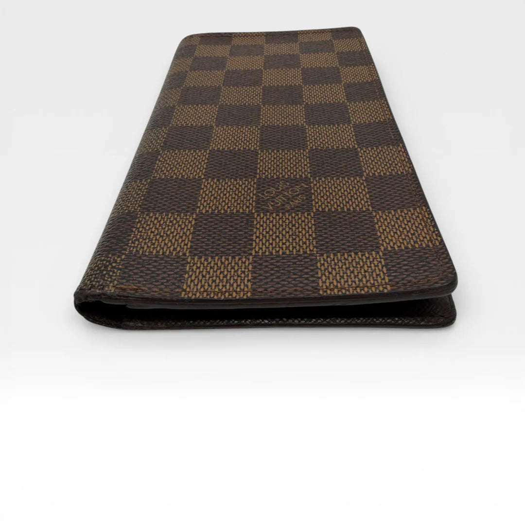 https://cdn.shopify.com/s/files/1/0564/9376/8855/files/Louis_Vuitton_Geldbeutel_Portefeuille_Damier_Ebene_braun_vintage_LV_8674.webp?v=1769075832