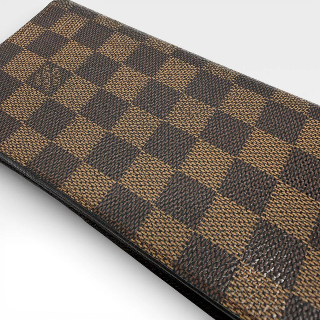 https://cdn.shopify.com/s/files/1/0564/9376/8855/files/Louis_Vuitton_Geldbeutel_Portefeuille_Damier_Ebene_braun_vintage_LV_8680.webp?v=1769075832
