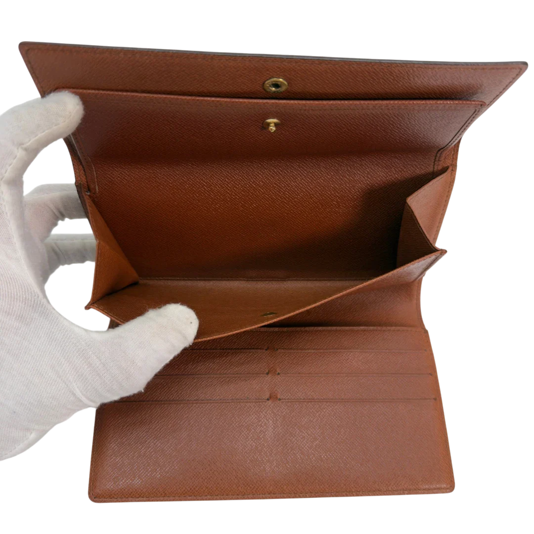 https://cdn.shopify.com/s/files/1/0564/9376/8855/files/Louis_Vuitton_Geldbeutel_Portefeuille_International_monogram_braun_vintage_LV8679.webp?v=1781083497