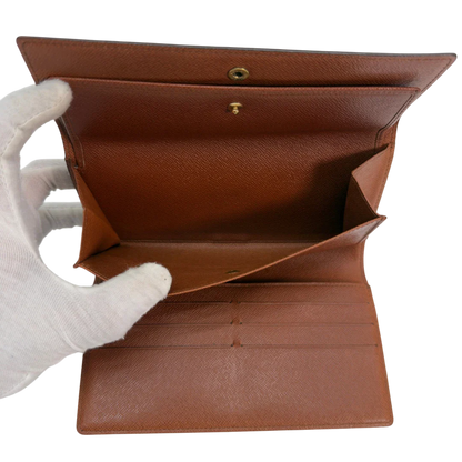 https://cdn.shopify.com/s/files/1/0564/9376/8855/files/Louis_Vuitton_Geldbeutel_Portefeuille_International_monogram_braun_vintage_LV8679.webp?v=1781083497