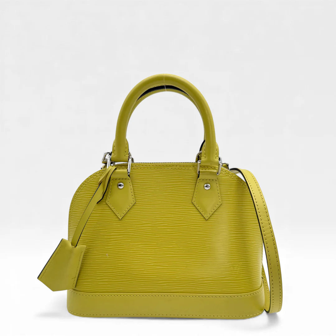 https://cdn.shopify.com/s/files/1/0564/9376/8855/files/Louis_Vuitton_Handtasche_Alma_BB_Epi_Leder_neongelb_vintage_LV_5764.webp?v=1765453969
