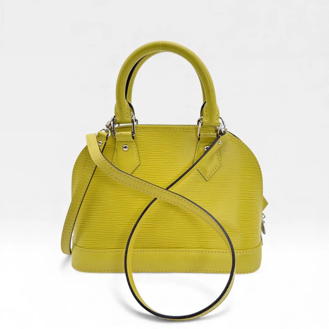 https://cdn.shopify.com/s/files/1/0564/9376/8855/files/Louis_Vuitton_Handtasche_Alma_BB_Epi_Leder_neongelb_vintage_LV_5765.webp?v=1765453895