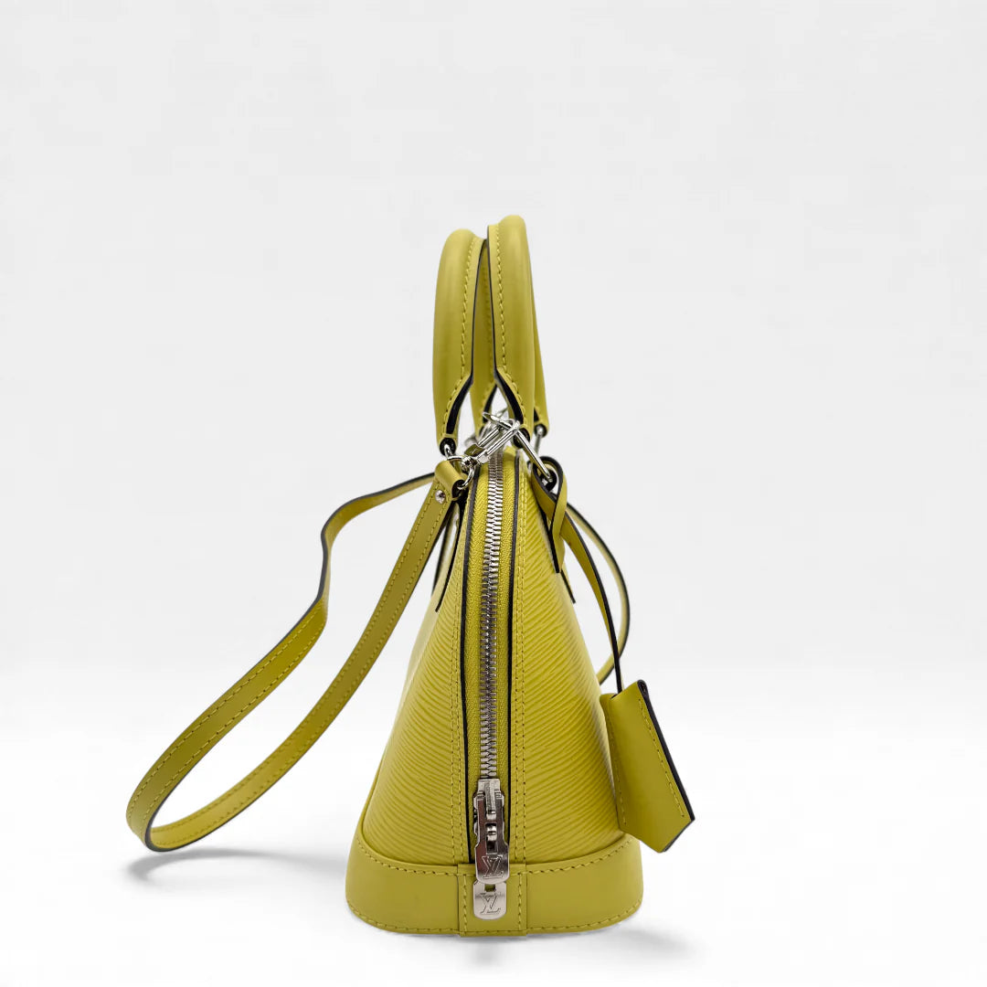 https://cdn.shopify.com/s/files/1/0564/9376/8855/files/Louis_Vuitton_Handtasche_Alma_BB_Epi_Leder_neongelb_vintage_LV_5766.webp?v=1765453895