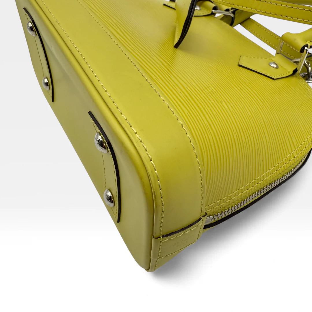 https://cdn.shopify.com/s/files/1/0564/9376/8855/files/Louis_Vuitton_Handtasche_Alma_BB_Epi_Leder_neongelb_vintage_LV_5769.webp?v=1765453895