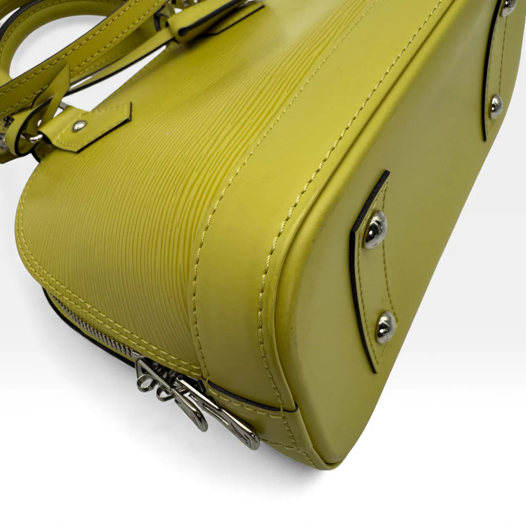 https://cdn.shopify.com/s/files/1/0564/9376/8855/files/Louis_Vuitton_Handtasche_Alma_BB_Epi_Leder_neongelb_vintage_LV_5770.webp?v=1765453896