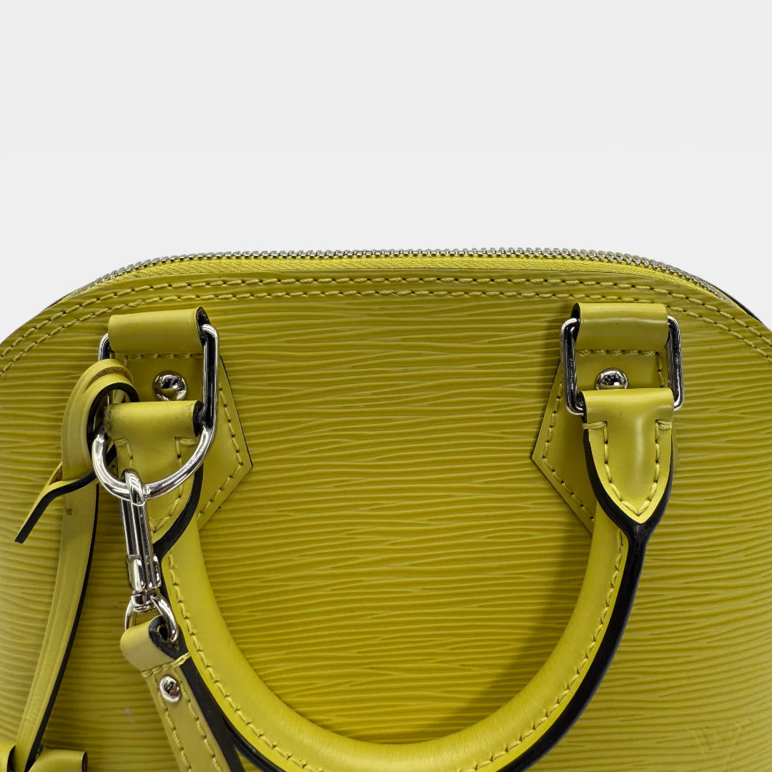 https://cdn.shopify.com/s/files/1/0564/9376/8855/files/Louis_Vuitton_Handtasche_Alma_BB_Epi_Leder_neongelb_vintage_LV_5776.webp?v=1765453895