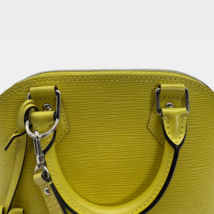 https://cdn.shopify.com/s/files/1/0564/9376/8855/files/Louis_Vuitton_Handtasche_Alma_BB_Epi_Leder_neongelb_vintage_LV_5776.webp?v=1765453895