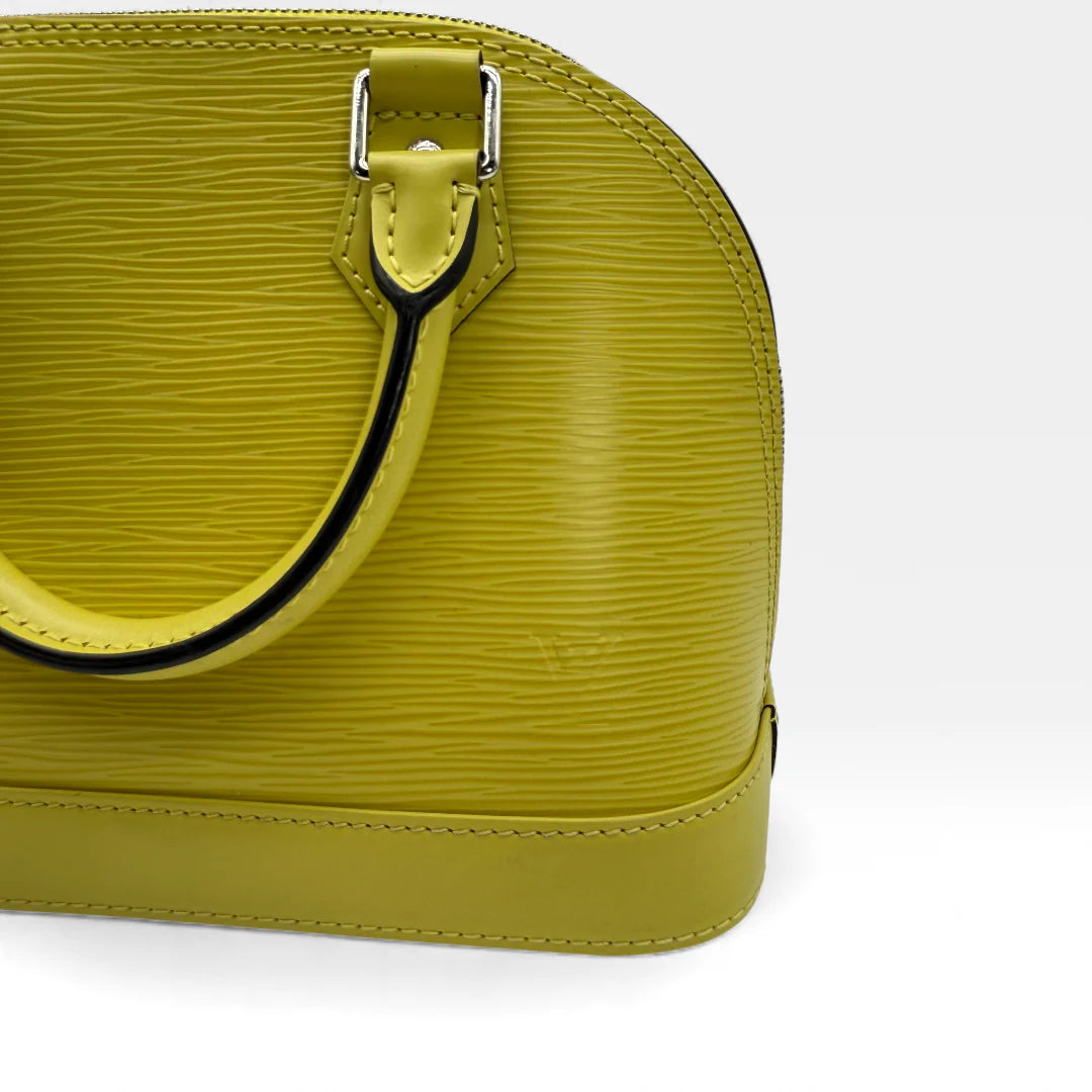 https://cdn.shopify.com/s/files/1/0564/9376/8855/files/Louis_Vuitton_Handtasche_Alma_BB_Epi_Leder_neongelb_vintage_LV_5777.webp?v=1765453895