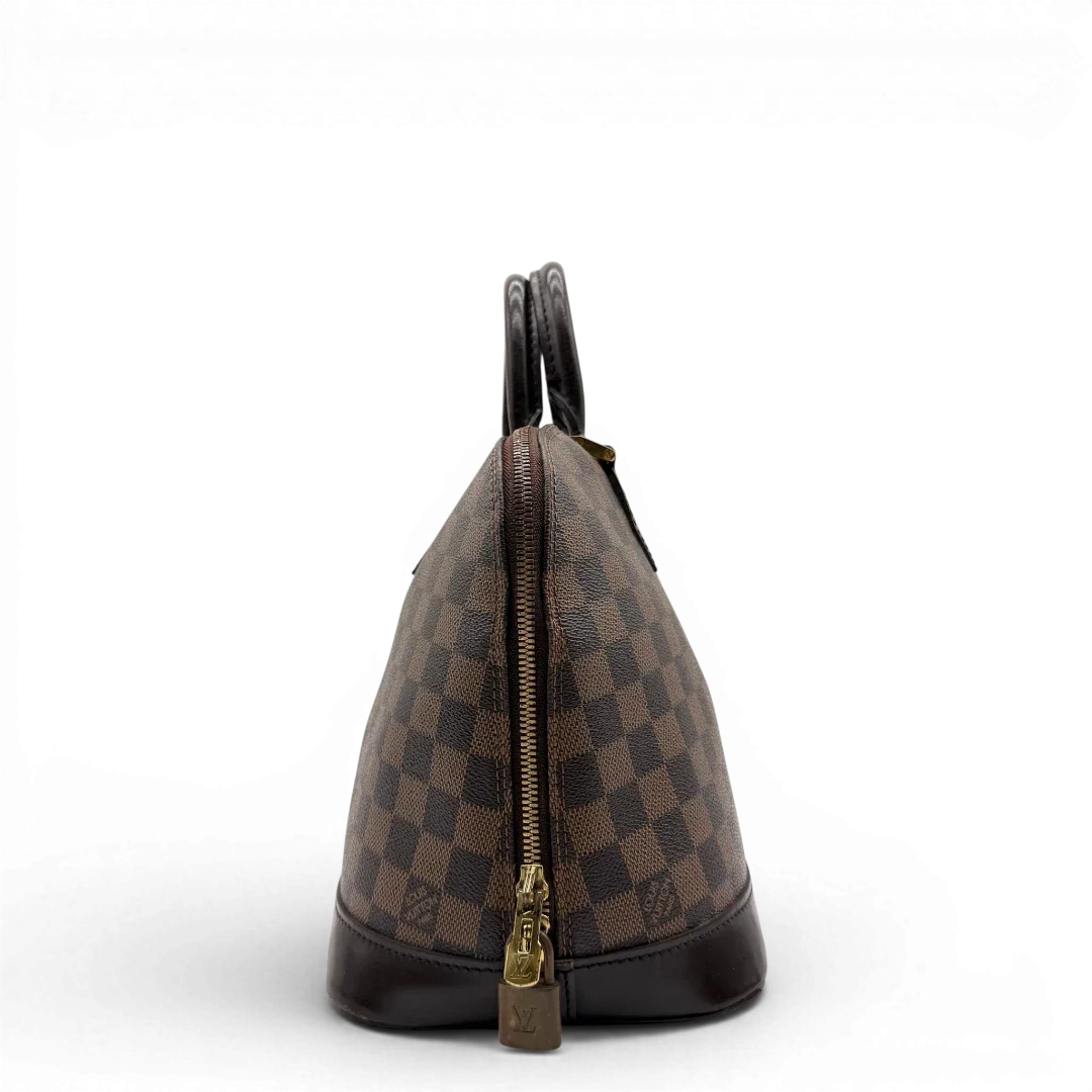 https://cdn.shopify.com/s/files/1/0564/9376/8855/files/Louis_Vuitton_Handtasche_Alma_MM_Damier_Ebene_braun_vintage_LV5936.webp?v=1778199020