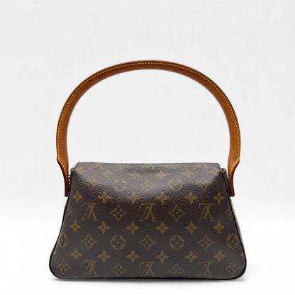 https://cdn.shopify.com/s/files/1/0564/9376/8855/files/Louis_Vuitton_Handtasche_Mini_Looping_monogram_braun_vintage_LV_handbag_5008.webp?v=1766066798
