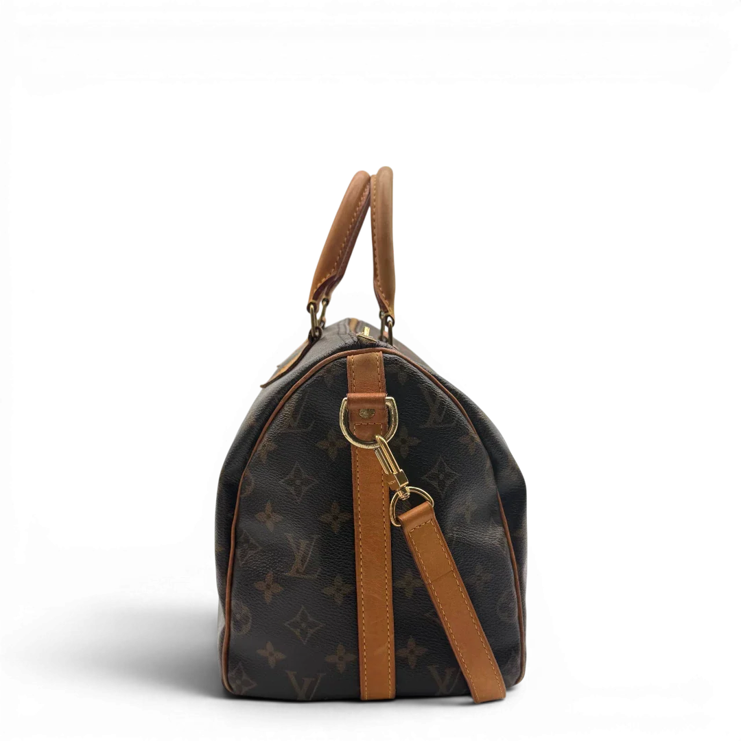 https://cdn.shopify.com/s/files/1/0564/9376/8855/files/Louis_Vuitton_Handtasche_Speedy_30_Bandouliere_monogram_braun_vintage_LV7465.webp?v=1779894866