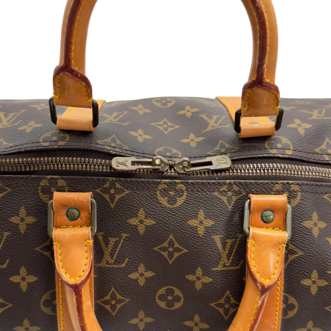 https://cdn.shopify.com/s/files/1/0564/9376/8855/files/Louis_Vuitton_Reisetasche_Keepall_50_monogram_braun_vintage_LV7752.webp?v=1779405988
