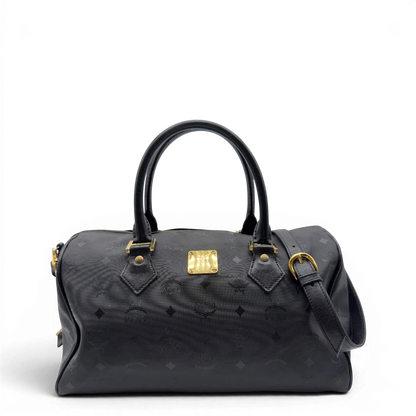 https://cdn.shopify.com/s/files/1/0564/9376/8855/files/MCM_Handtasche_Boston_35_vintage_mit_Umhangegurt_aus_PVC_schwarz_vintage7911.webp?v=1779969405
