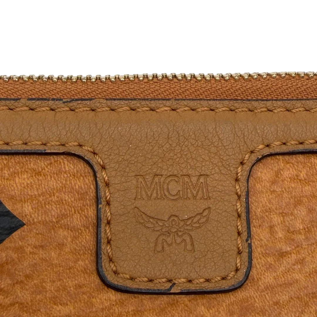 https://cdn.shopify.com/s/files/1/0564/9376/8855/files/MCM_Pochette_visetos_braun_10.webp?v=1781855350