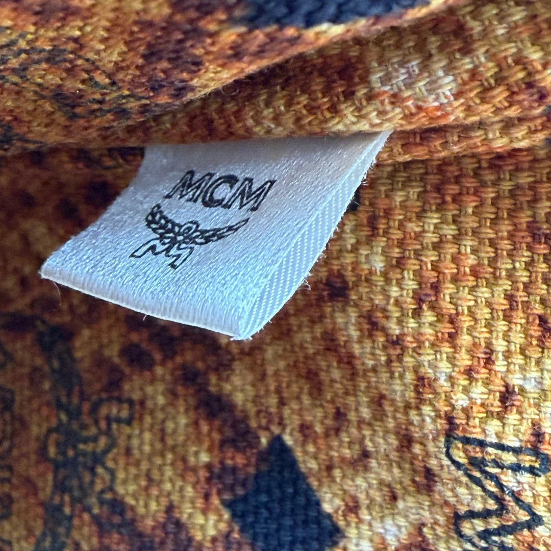 https://cdn.shopify.com/s/files/1/0564/9376/8855/files/MCM_Pochette_visetos_braun_16.webp?v=1781855350