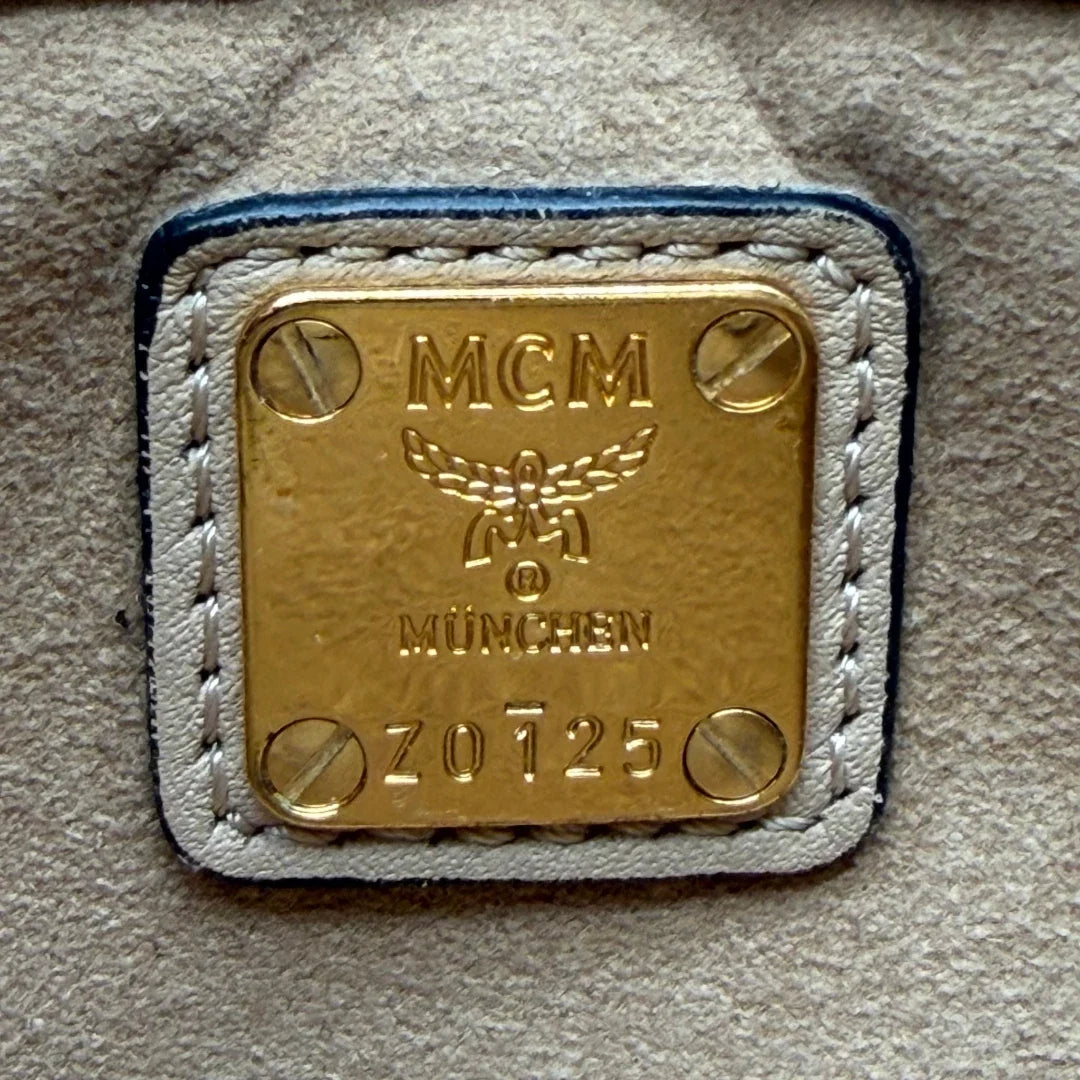 https://cdn.shopify.com/s/files/1/0564/9376/8855/files/MCM_Umhangetasche_Millie_Flap_visetos_beige_17.webp?v=1784795374