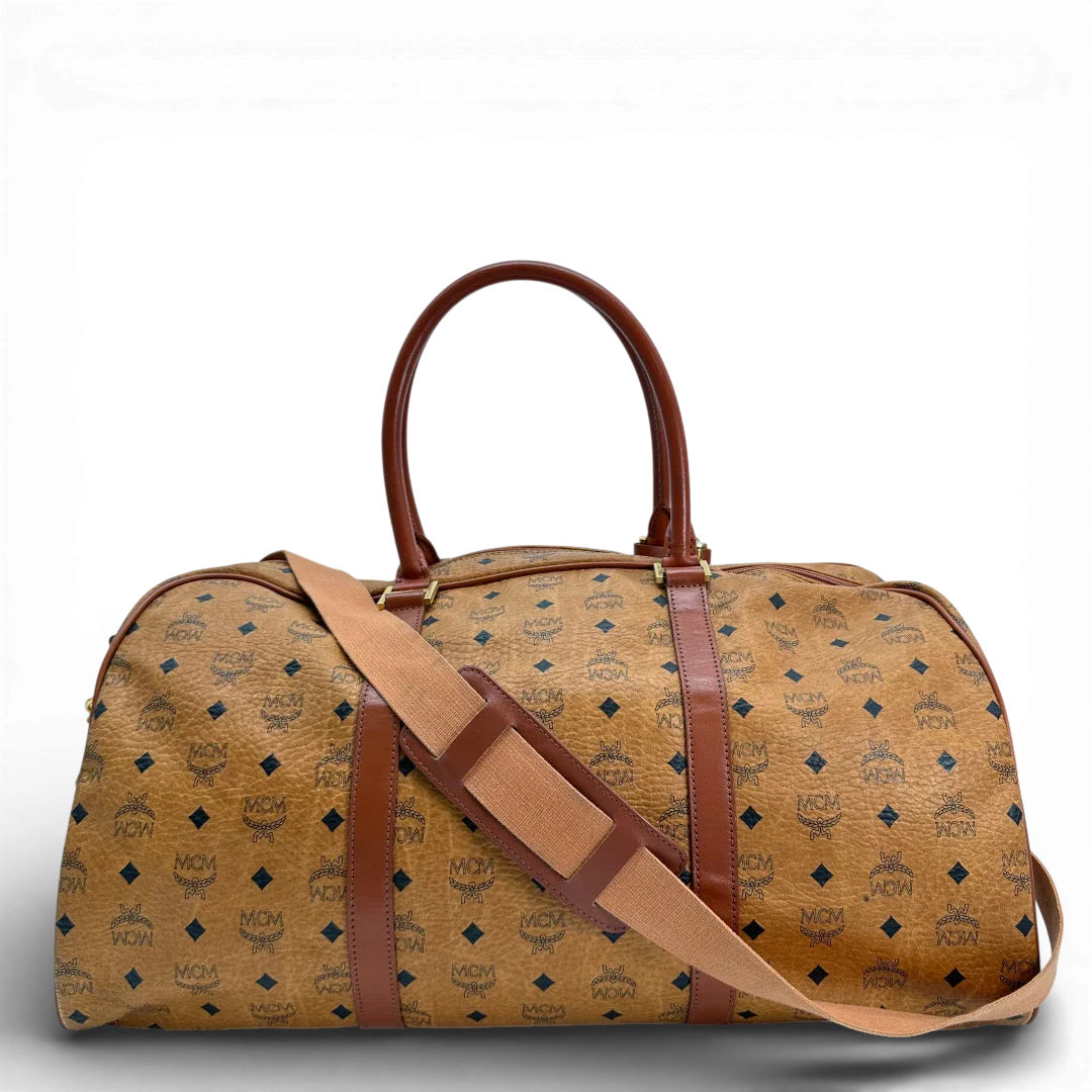 https://cdn.shopify.com/s/files/1/0564/9376/8855/files/Mcm_Reisetasche_55_mit_Schultergurt_Visetos_braun_vintage_2817.webp?v=1772707822