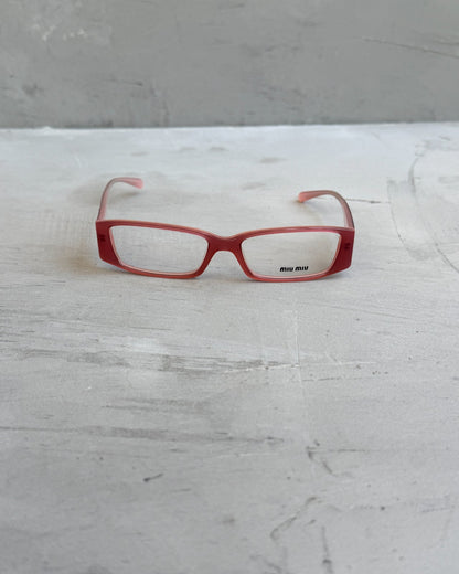 Miu Miu Pink Clear Lens Glasses-on a concrete background