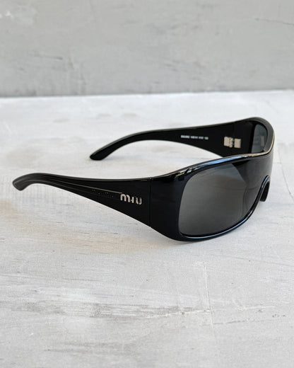 Miu Miu Black Wraparound Sunglasses-on a concrete background