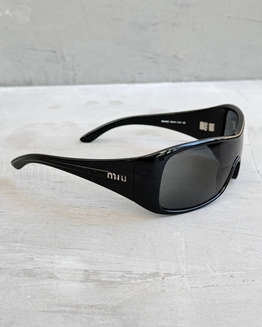 Miu Miu Black Wraparound Sunglasses-on a concrete background