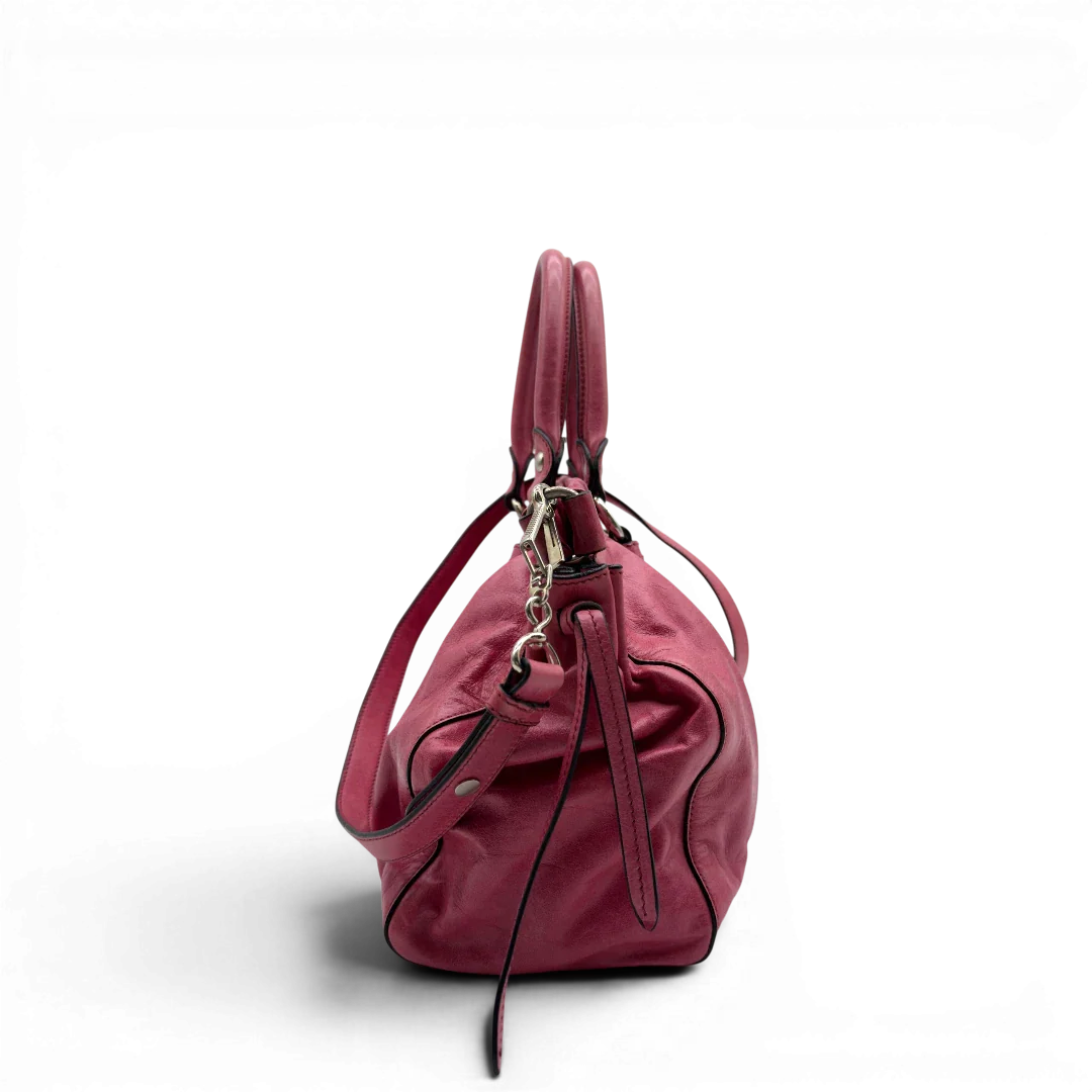https://cdn.shopify.com/s/files/1/0564/9376/8855/files/Miu_Miu_Handtasche_Vitello_Lux_mit_Umhangegurt_aus_Leder_pink_vintage7949.webp?v=1779965633