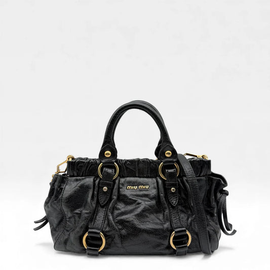 https://cdn.shopify.com/s/files/1/0564/9376/8855/files/Miu_Miu_Handtasche_Vitello_Lux_small_aus_Leder_schwarz_vintage_handbag4852.webp?v=1764951323