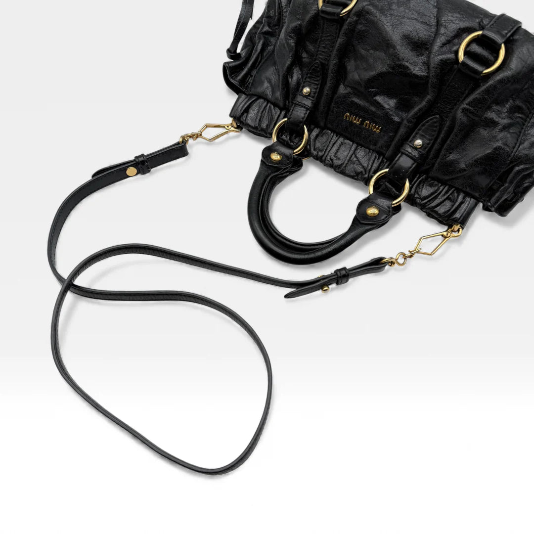 https://cdn.shopify.com/s/files/1/0564/9376/8855/files/Miu_Miu_Handtasche_Vitello_Lux_small_aus_Leder_schwarz_vintage_handbag4879.webp?v=1764952235