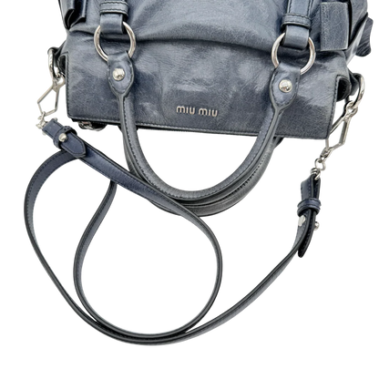 https://cdn.shopify.com/s/files/1/0564/9376/8855/files/Miu_Miu_Handtasche_Vitello_Satchel_small_mit_Umhaengegurt_aus_Leder_dunkelblau_vintage_0156.webp?v=1770280843