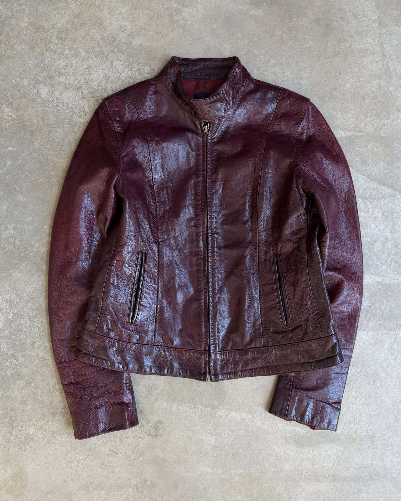 Transmission New York Oxblood Red Leather Jacket – L-on a concrete background