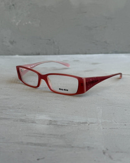 Miu Miu Pink Clear Lens Glasses-on a concrete background