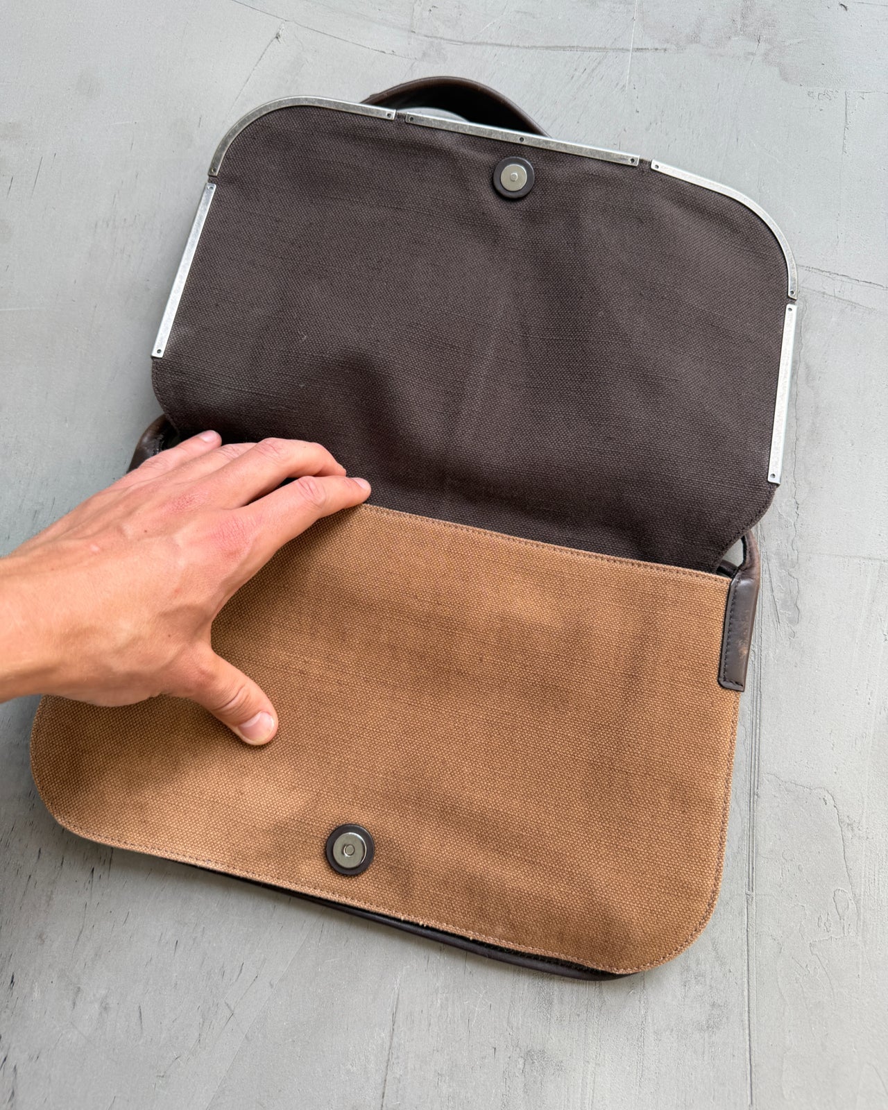 Yves Saint Laurent Brown Canvas Shoulder Bag-on a concrete background