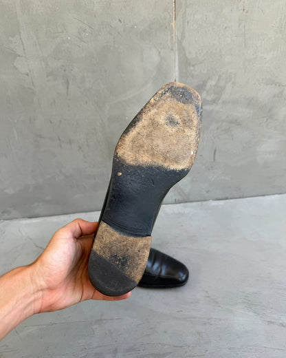 Prada Black Leather Loafers – UK 8.5-on a concrete background