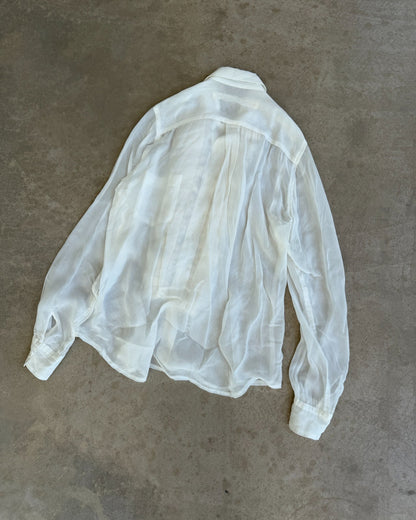 Comme des Garçons Sheer White Shirt-on a concrete background