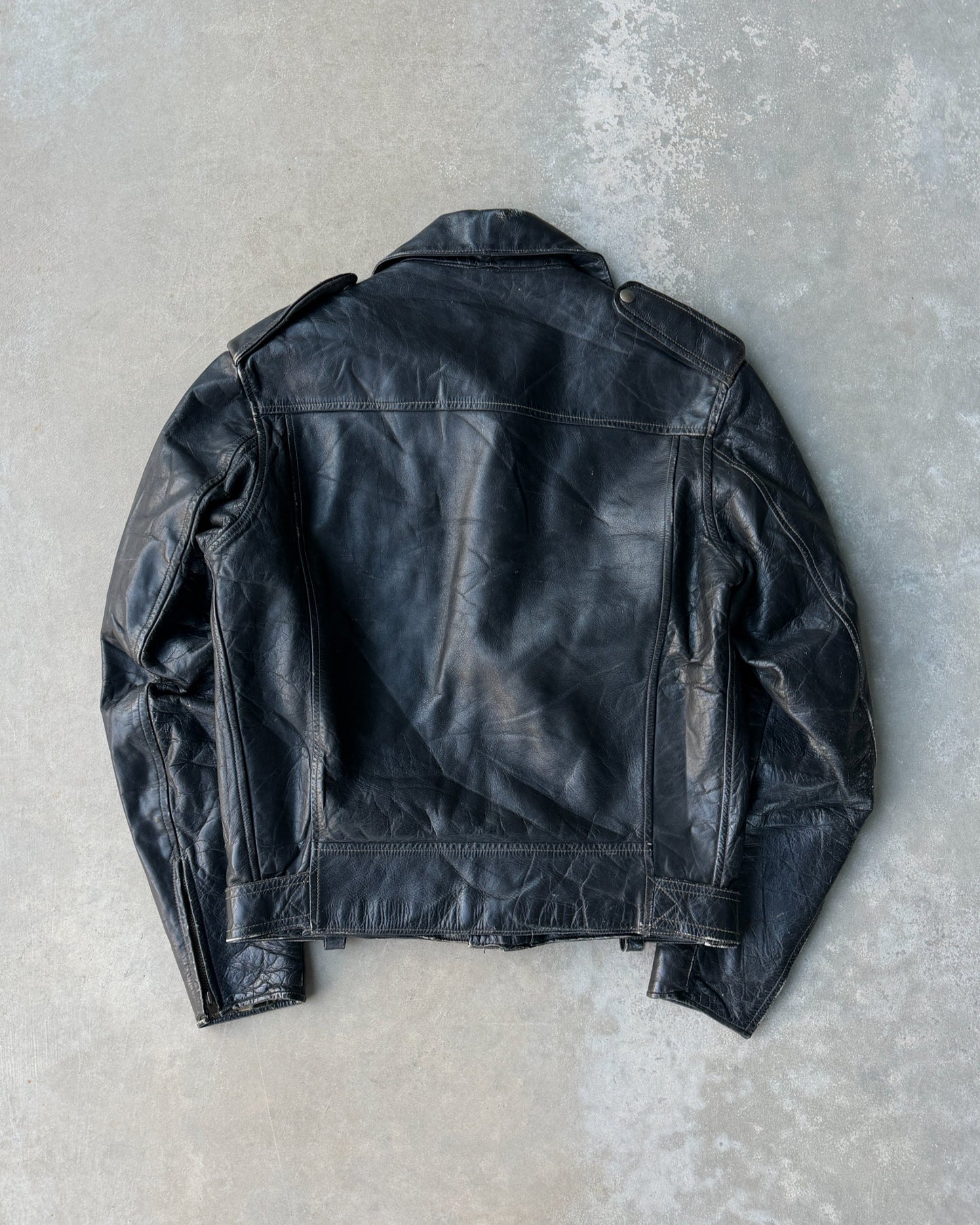 1960s Staggs Leather Moto Jacket – S-on a concrete background
