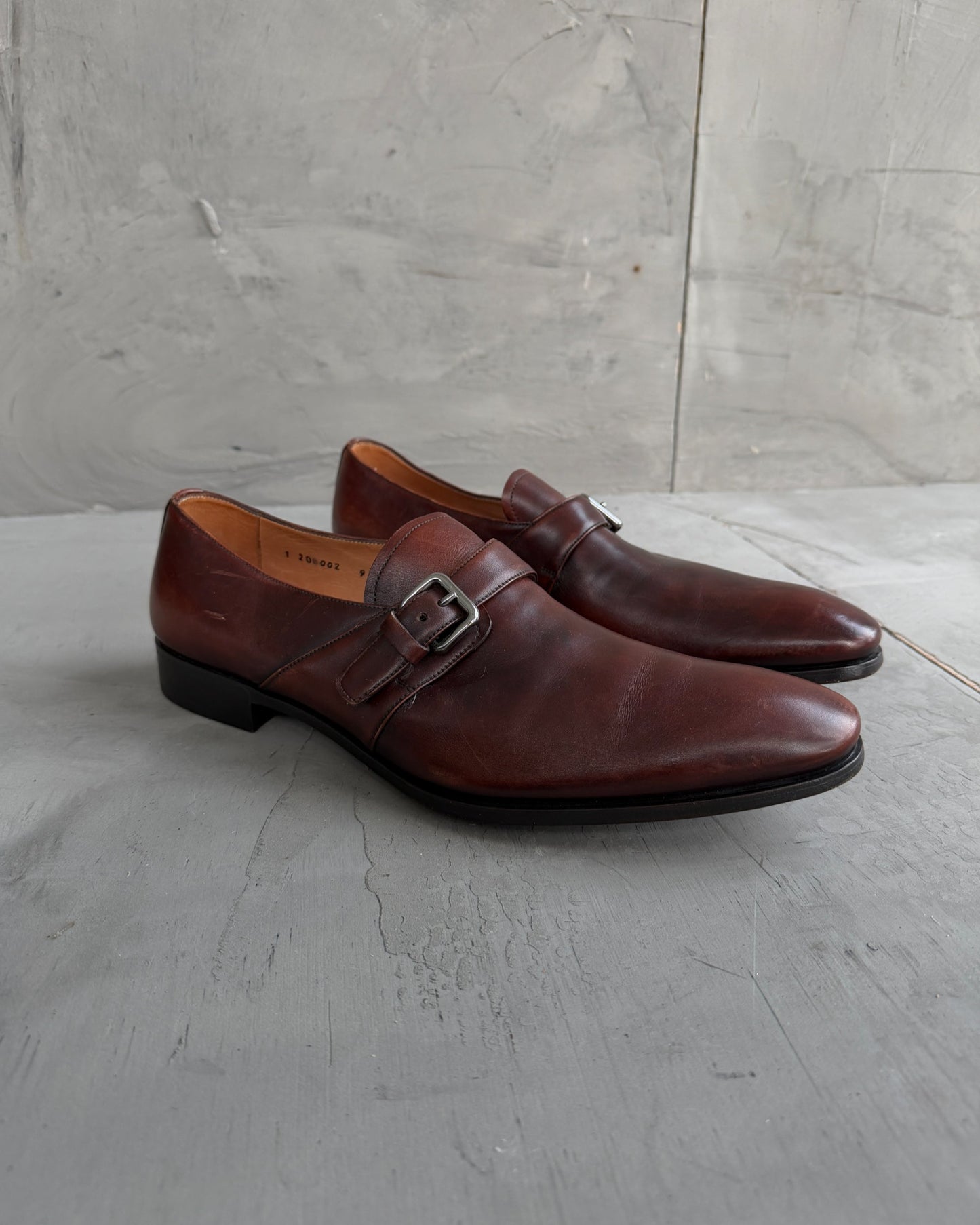 Prada Buckle Leather Derbys – UK 9-on a concrete background