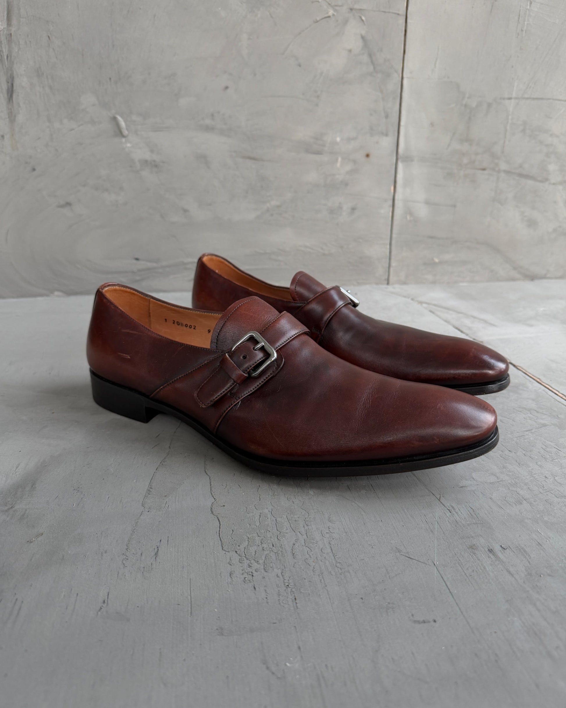 Prada Buckle Leather Derbys – UK 9-on a concrete background