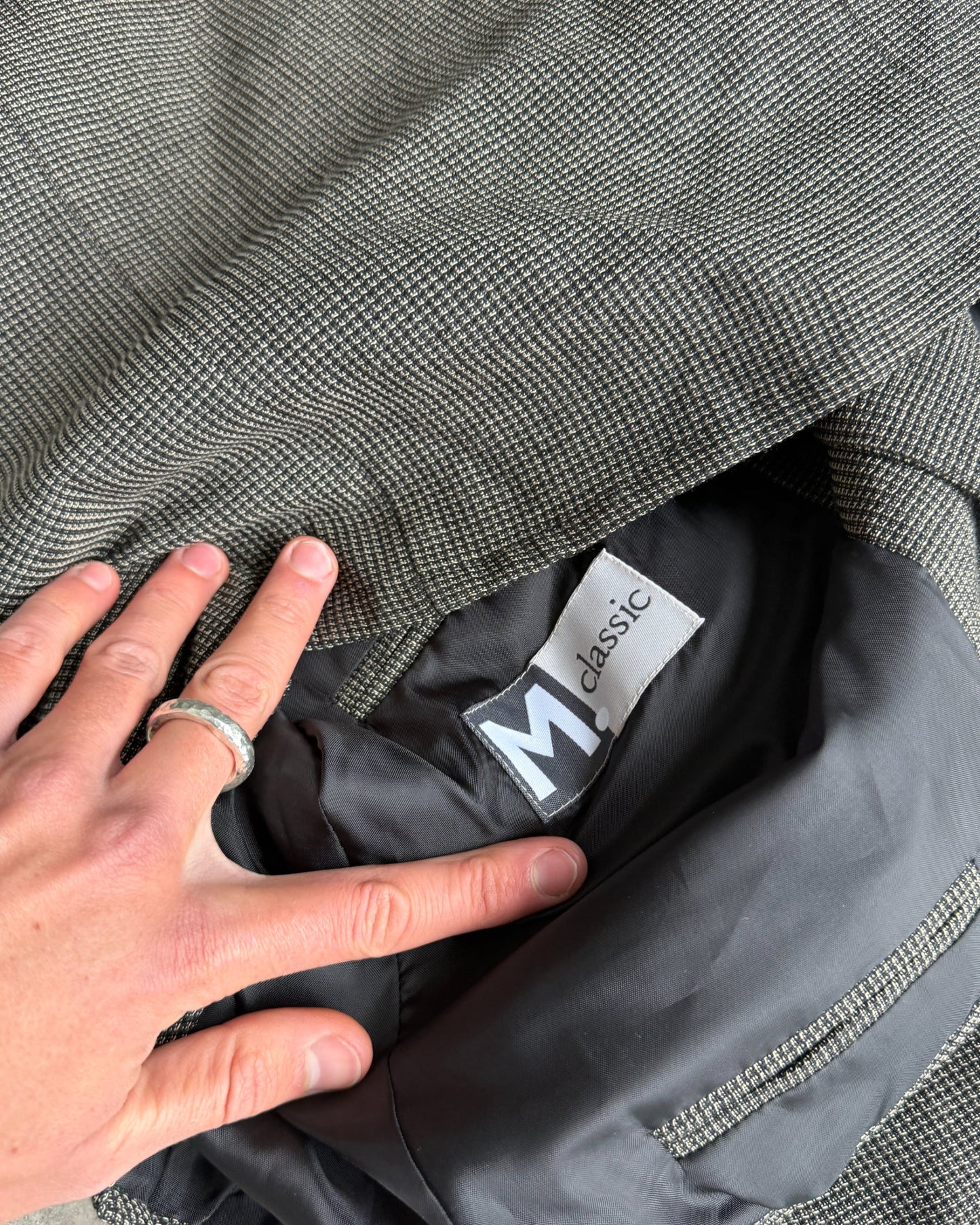 M Classic Altered Wool Jacket with Safety Pins – L-on a concrete background