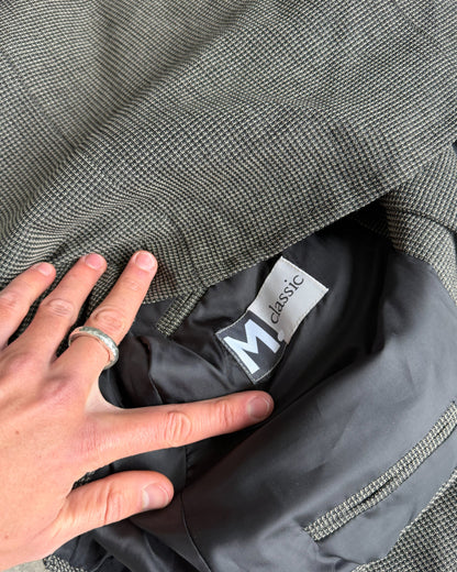 M Classic Altered Wool Jacket with Safety Pins – L-on a concrete background