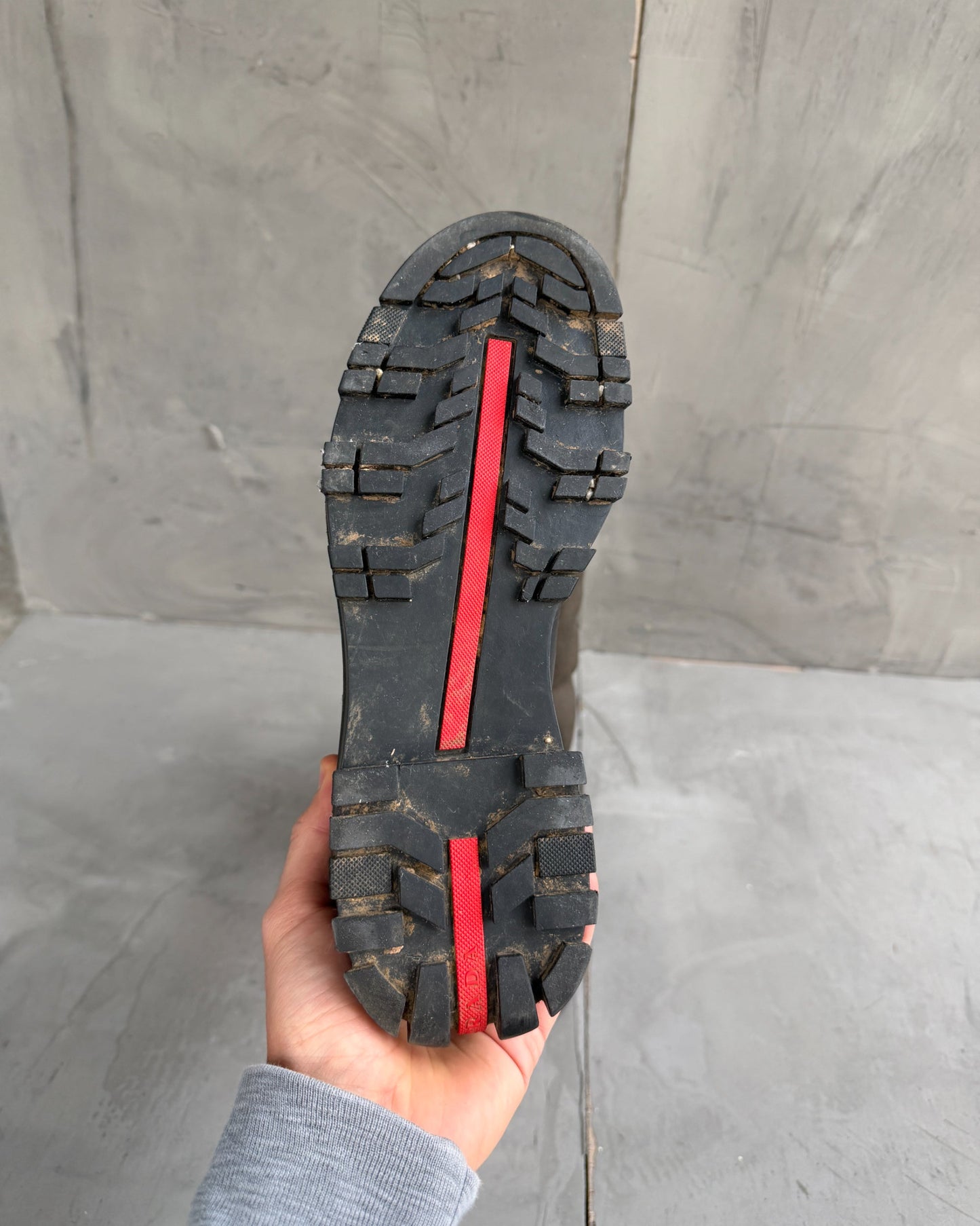 Prada Lug Sole Leather and Neoprene Boots – EU 38-on a concrete background