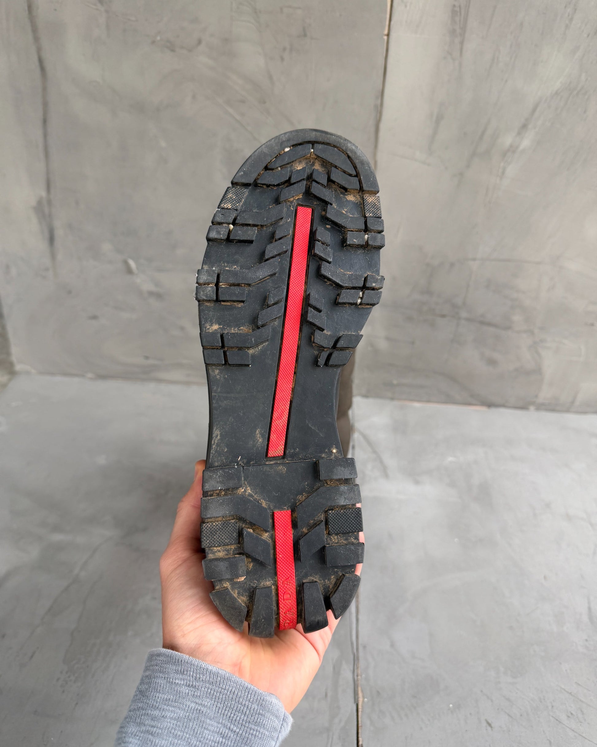 Prada Lug Sole Leather and Neoprene Boots – EU 38-on a concrete background