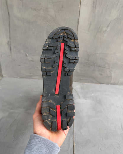 Prada Lug Sole Leather and Neoprene Boots – EU 38-on a concrete background