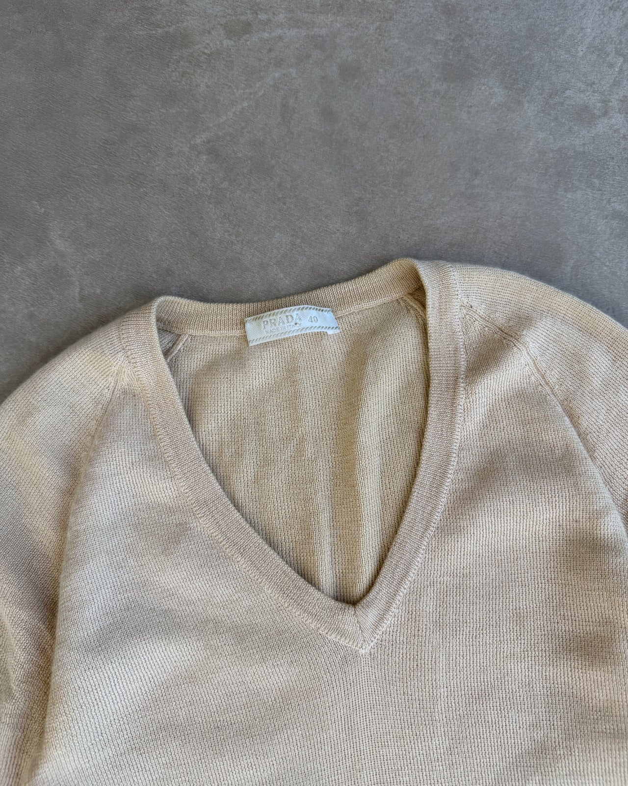 Prada Cashmere Silk Blend V Neck T-Shirt – S-on a concrete background