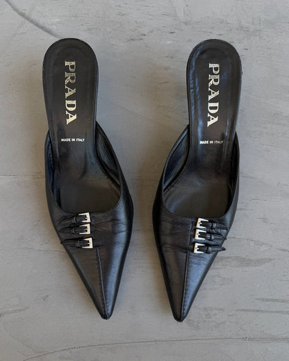 Prada Black Leather Triple Buckle Kitten Heel Mule – EU 37-on a concrete background