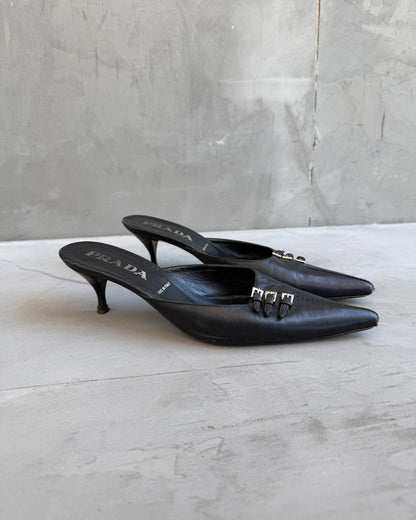 Prada Black Leather Triple Buckle Kitten Heel Mule – EU 37-on a concrete background