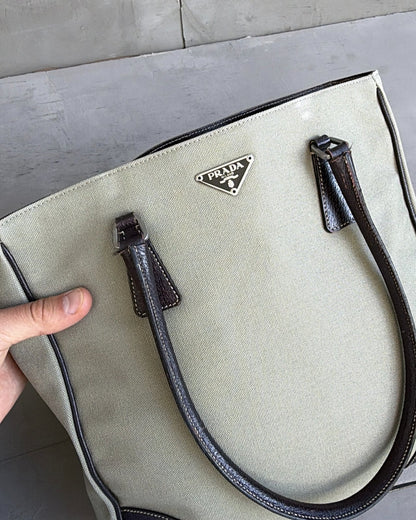 Prada Canvas and Leather Tote Bag-on a concrete background