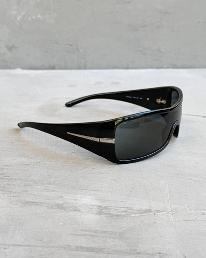 Prada Black Wraparound Sunglasses-on a concrete background