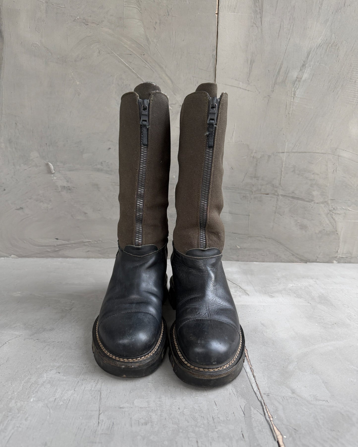 Prada Lug Sole Leather and Neoprene Boots – EU 38-on a concrete background