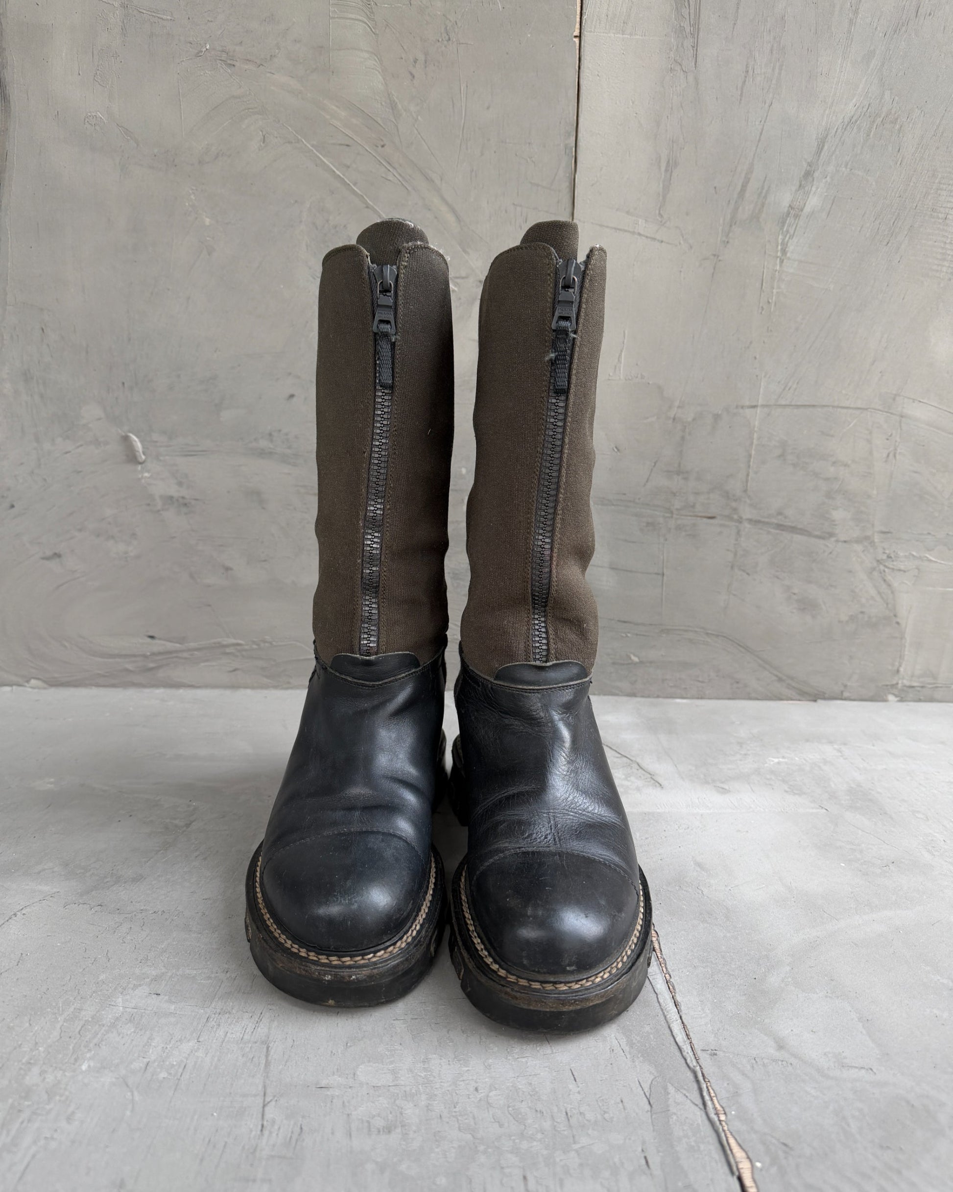 Prada Lug Sole Leather and Neoprene Boots – EU 38-on a concrete background