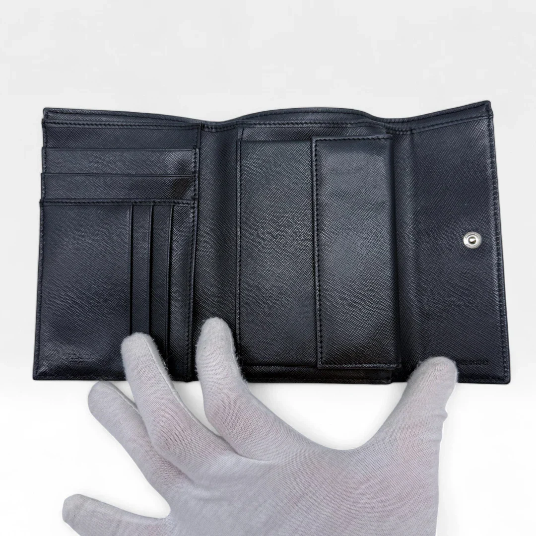 https://cdn.shopify.com/s/files/1/0564/9376/8855/files/Prada_Geldbeutel_aus_Nylon_schwarz_vintage_wallet9789.webp?v=1758649692