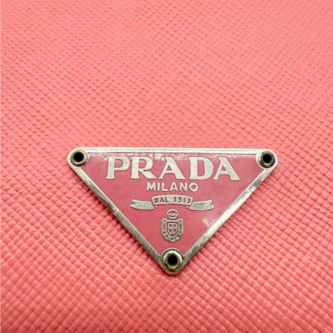 https://cdn.shopify.com/s/files/1/0564/9376/8855/files/Prada_Geldbeutel_aus_Saffiano_Leder_pink_vintage_1730.webp?v=1772101926